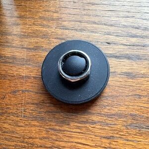 Oura Black Smart Ring on Black Charging Dock